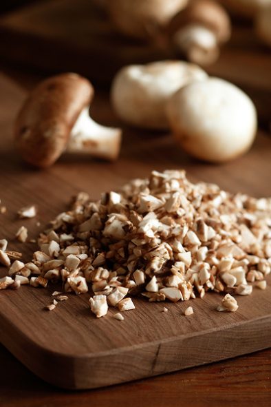 Diced mushrooms on a cutting board.