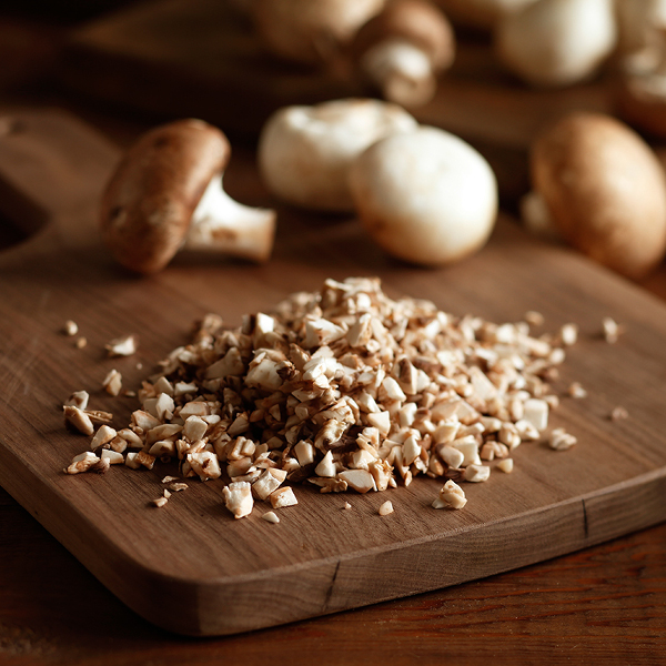 Diced mushrooms on a cutting board.