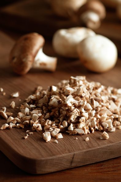 Diced mushrooms on a cutting board.