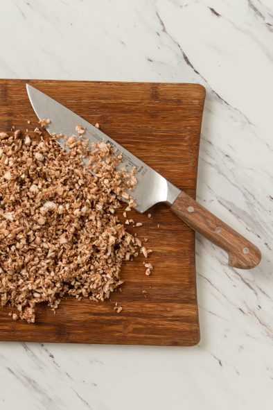 Chopped mushrooms on a cutting board.