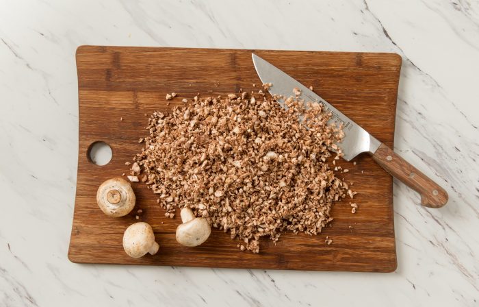 Chopped mushrooms on a cutting board.