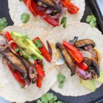 Three mushroom fajitas served on a sheetpan.
